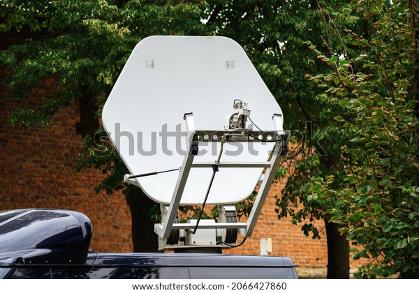 Portable satellite dish\
for live TV broadcasting. TV company equipment installed on the\
car. Close-up