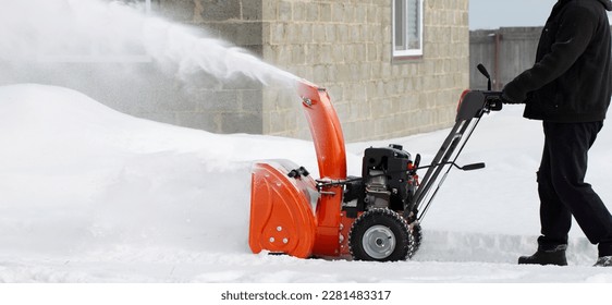 A portable snow blower powered by gasoline. Snow removal in winter. - Powered by Shutterstock