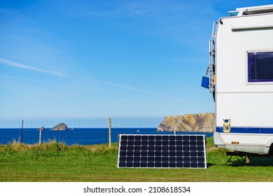 Portable solar photovoltaic panel, charging battery at camper car rv camping on spanish coast. - Shutterstock ID 2108618534