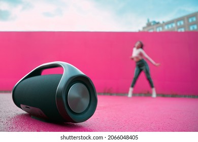 Portable Speaker For Playing Music, Product Presentation On Outdoor Dance Floor. Advertising Of Wireless Audio Device