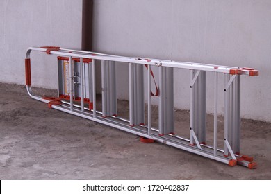 Portable Step Ladder Placed Horizontally On The Ground.