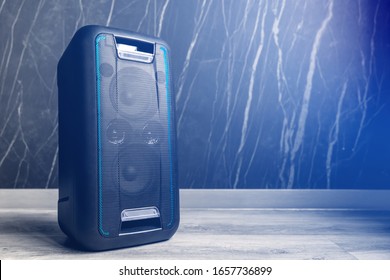 Portable wireless bluetooth speaker on dark background. Copy space