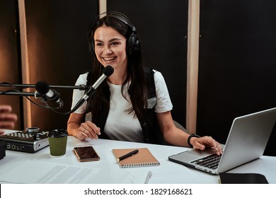 Portait Of Attractive Young Female Radio Host Speaking In Microphone While Moderating A Live Show