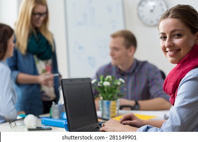 Portait Of Smiling Young Intern At Office