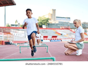 Portait of sports coach, children at stadium having althletics training. Portrait of athlete group, coaching and training at sport academy - Powered by Shutterstock