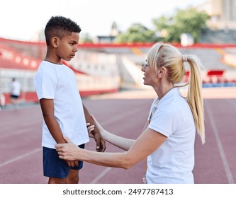 Portait of sports coach, children at stadium having althletics training. Portrait of athlete group, coaching and training at sport academy, support, teamwork, determination, togetherness concepts - Powered by Shutterstock