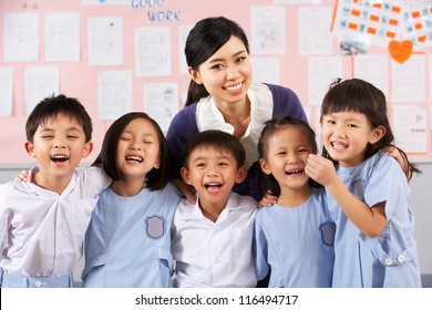 Portait Of Teacher And Students In Chinese School Classroom