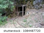 portal of an abandoned gold mine on the side of a mountain