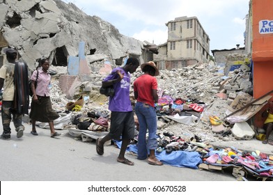 PORT-AU-PRINCE - AUGUST 21: People buying and selling stuffs in front of a collapsed building in   Port-Au-Prince, Haiti on August 21  2010.
