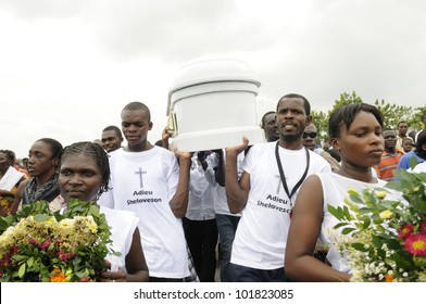 PORT-AU-PRINCE - SEPTEMBER  1:  Pall-bearers Dancing While Carrying The Casket Of A 6 Months Old Baby Who Was Burnt Alive Inside His Tent   On September 1 2010 In Port-Au-Prince, Haiti.