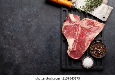 Porterhouse Or T-bone Raw Beef Steak With Herbs And Spices Over Grill. Top View Flat Lay With Copy Space