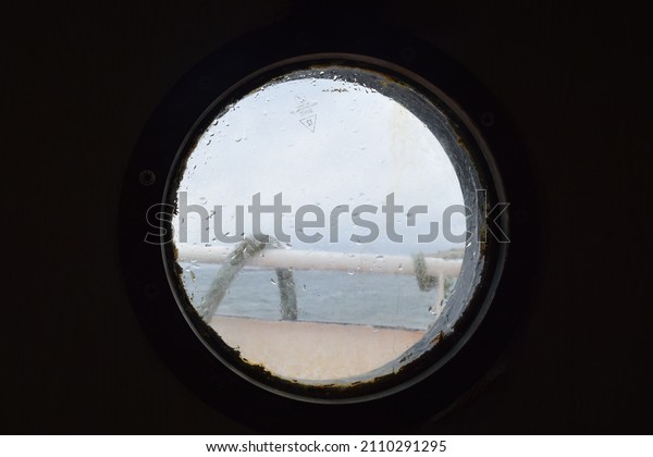 Porthole, a little but beautiful look\
on the sea. Boat porthole. Sea life. Sailors.\
Sailing.