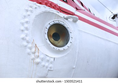 Porthole of an old submarine shot close-up