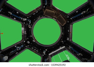 Porthole of space station isolated on green background. Elements of this image furnished by NASA.