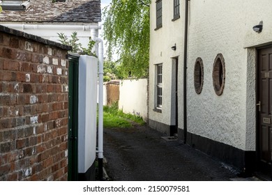 Porthole Windows In Side Of Whitewashed House With Willow Tree In Topsham Devon UK