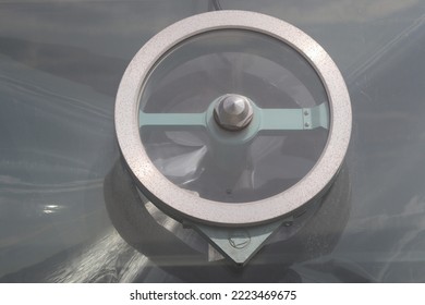 A porthole-mounted clear view screen or mist glass is a window-mounted glass disk that rotates to disperse rain, spray, and snow - Shutterstock ID 2223469675