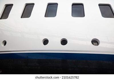 Portholes On The Hull Of A Luxury Yacht, Above The Waterline, Side View.