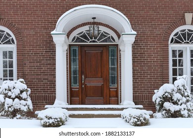 Portico Entrance With Elegant Wood Grain Front Door, House In Winter