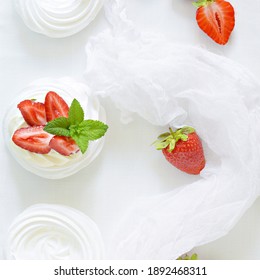 Portion Australian Dessert Pavlova With Airy Butter Cream, Fresh Strawberries And Mint On A White Plate.