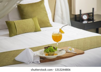 A portion of avocado salad with lettuce and freshly squeezed orange juice served in a hotel room, room service, healthy start of the day - Shutterstock ID 1313244806