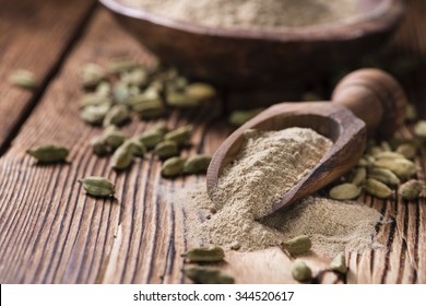 Portion Of Cardamon Powder (close-up Shot) On Wooden Background
