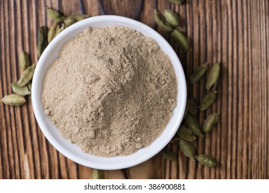 Portion Of Cardamon Powder (close-up Shot) On Wooden Background
