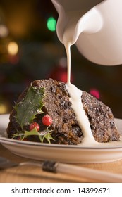 Portion Of Christmas Pudding With Pouring Cream