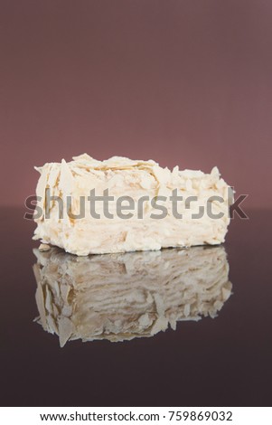 Portion of classic Napoleon cake on mirror table. Traditional millefeuille dessert with puff pastry and custard, russian cuisine treat, copy space