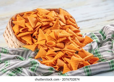 Portion Of Cone Shaped Snack Tornado Shaped Crackers. Yellow Spicy Potato Cone Chips Texture Or Background Of Corn Cone. 