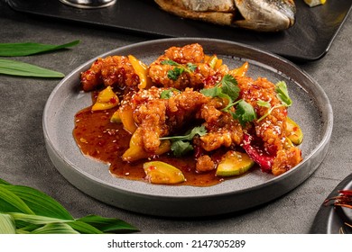 Portion of cooked walleye fish with sweet and sour sauce