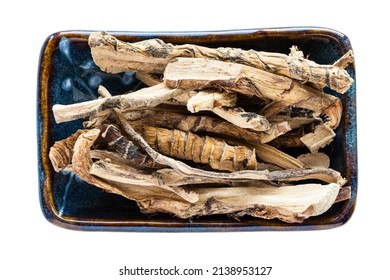 portion of dried Sweet flag (calamus) roots in bowl isolated on white background