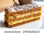 Portion of french mille-feuille cake, vanilla or custard slice, Napoleon puff pastry layered with pastry cream in French bakery