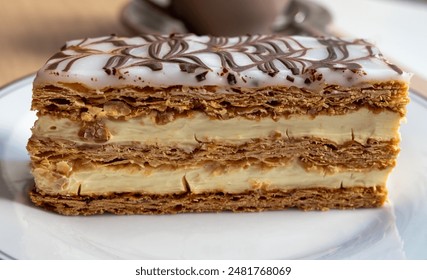 Portion of french mille-feuille cake, vanilla or custard slice, Napoleon puff pastry layered with pastry cream in French bakery - Powered by Shutterstock