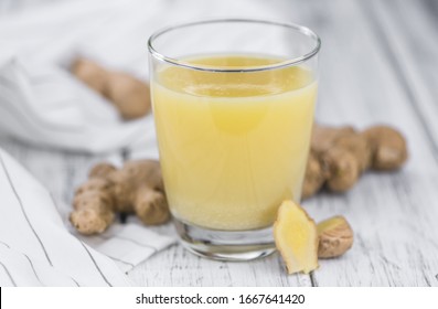 Portion of fresh Ginger Juice (selective focus; close-up shot)
