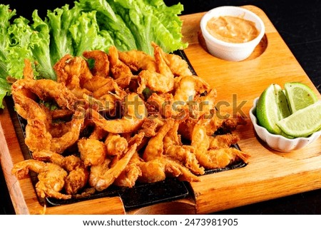 Portion of fried shrimp, breaded shrimp. With selective focus (Porção de camaroes)