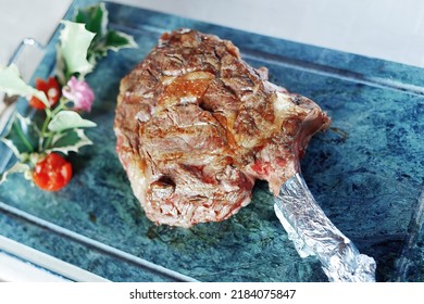 Portion Of Grilled Ribeye Steak On The Bone Served Whole On Stone