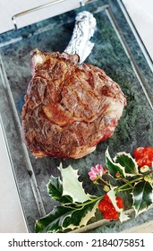 Portion Of Grilled Ribeye Steak On The Bone Served Whole On Stone