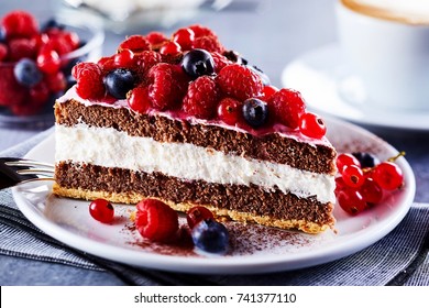 Portion of layered creamy fruit cake with in close up view - Powered by Shutterstock