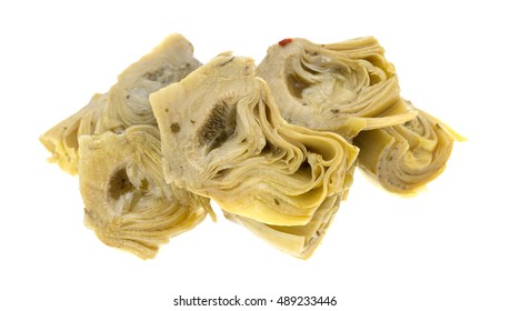 A portion of marinated artichoke hearts isolated on a white background.