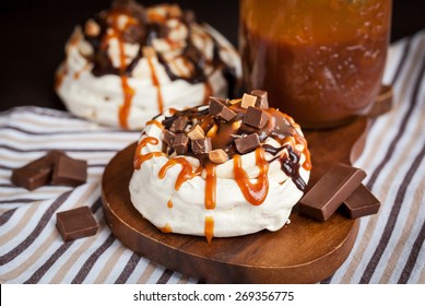 Portion Of Mini Pavlova Meringue Cake Decorated With Chocolate, Toffee And Caramel Sauce