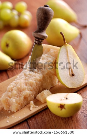 portion of parmesan cheese with pears around