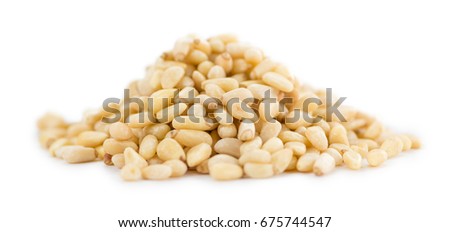 Portion of Pine Nuts (as close-up shot) isolated on white background