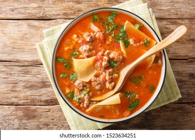 Portion Of Rich Lasagna Soup Close-up In A Plate On The Table. Horizontal Top View From Above
