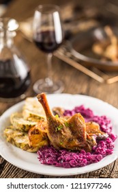 Portion Of Roast Duck Leg Red Cabbage Homemade Dumplings On Plate And Red Wine On The Background.