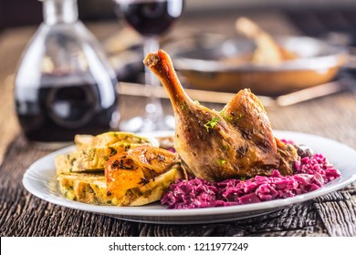 Portion Of Roast Duck Leg Red Cabbage Homemade Dumplings On Plate And Red Wine On The Background.