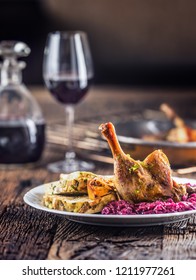 Portion Of Roast Duck Leg Red Cabbage Homemade Dumplings On Plate And Red Wine On The Background.