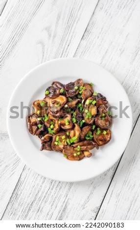Portion of sauteed shiitake mushrooms on the plate