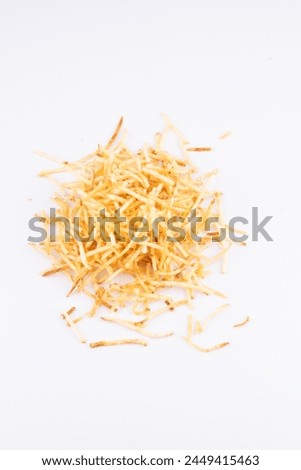 portion of shoestring potatoes scattered on white background