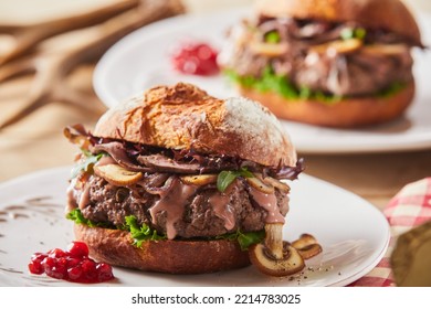 Portion Of Tasty Burger With Fresh Bun And Thick Beef Patty Served On Plate With Berry Sauce During Lunch