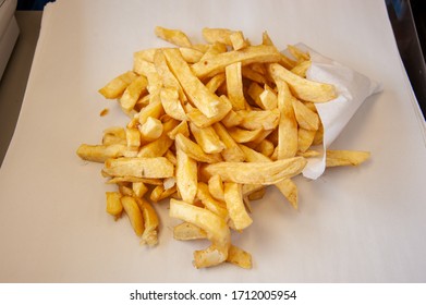 Portion of unhealthy food of chips at fish and chip shop, UK